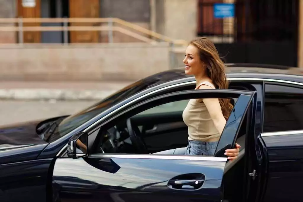 happy woman TLC woman driver at car in new York city road